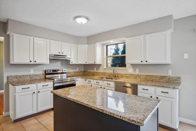 kitchen featuring stainless steel appliances, a sink, white cabinets, and under cabinet range hood