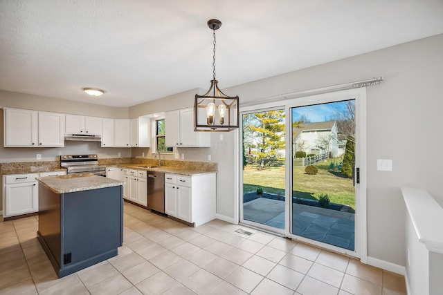 kitchen featuring under cabinet range hood, stainless steel appliances, a kitchen island, a sink, and white cabinets