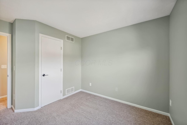 carpeted empty room with baseboards and visible vents