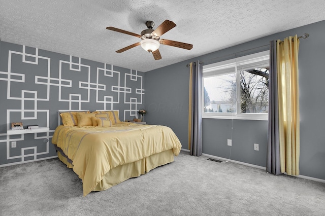 bedroom featuring ceiling fan, carpet floors, and a textured ceiling