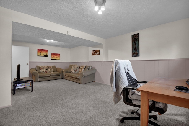 carpeted home office with a textured ceiling