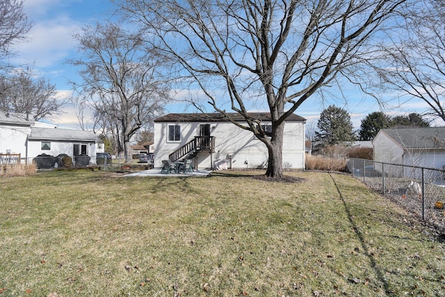 rear view of house with a yard and a patio area