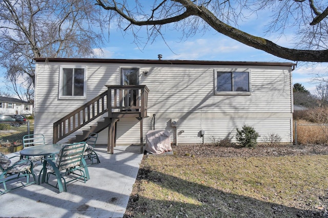 back of property featuring a lawn and a patio area