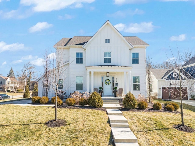 modern farmhouse featuring covered porch, an attached garage, board and batten siding, driveway, and a front lawn