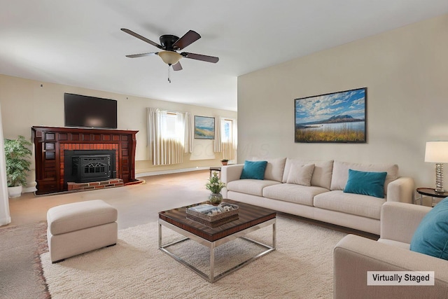 carpeted living room featuring a brick fireplace and ceiling fan