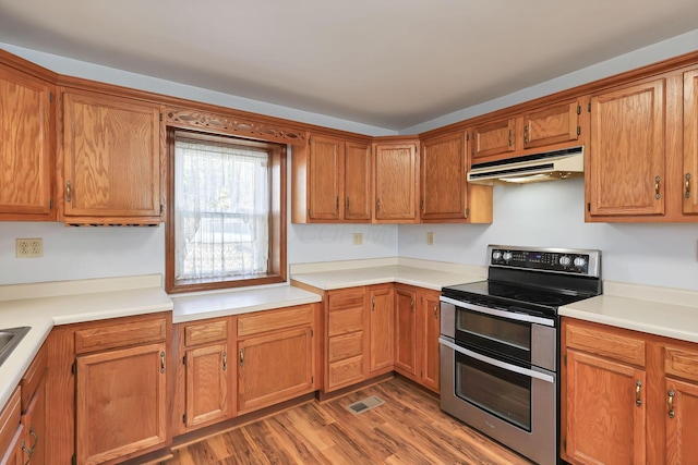 kitchen featuring dark hardwood / wood-style flooring and double oven range