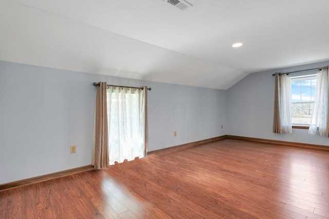 bonus room featuring lofted ceiling and hardwood / wood-style flooring