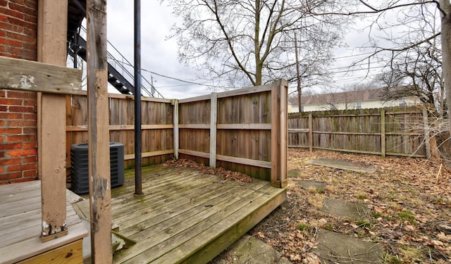 wooden deck featuring central air condition unit