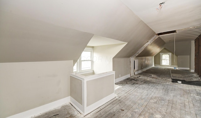 bonus room featuring hardwood / wood-style flooring and lofted ceiling