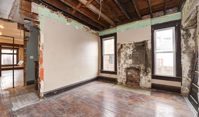 misc room with a healthy amount of sunlight, a fireplace, and hardwood / wood-style floors