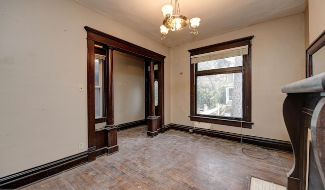 unfurnished room featuring an inviting chandelier