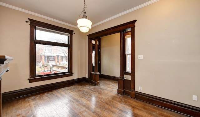 spare room featuring wood-type flooring and ornamental molding