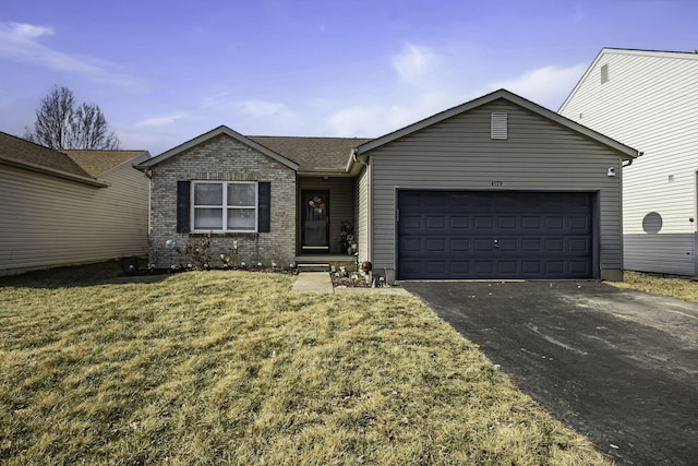 ranch-style home with a garage and a front lawn