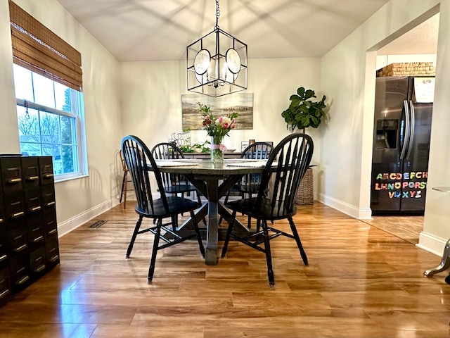 dining room featuring an inviting chandelier and hardwood / wood-style floors