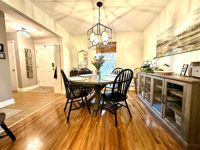 dining space featuring hardwood / wood-style floors and a notable chandelier