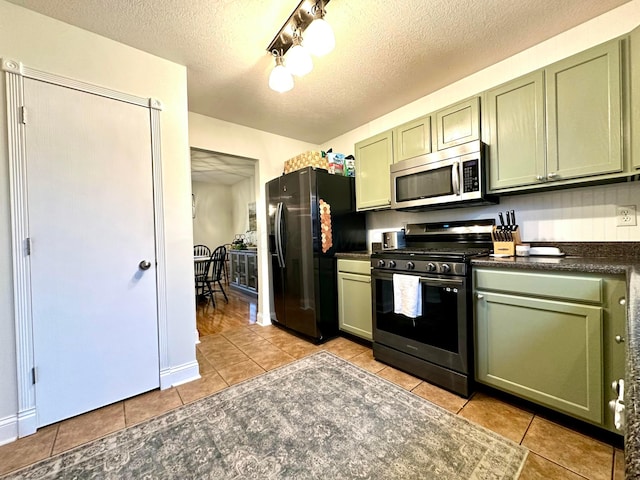 kitchen with green cabinetry and stainless steel appliances