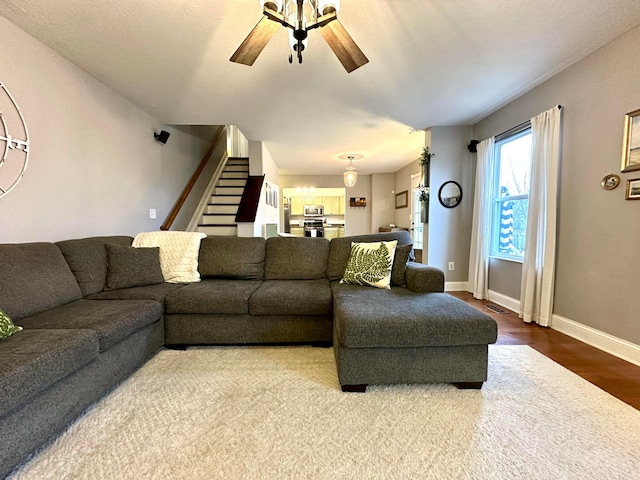 living room with hardwood / wood-style floors and ceiling fan