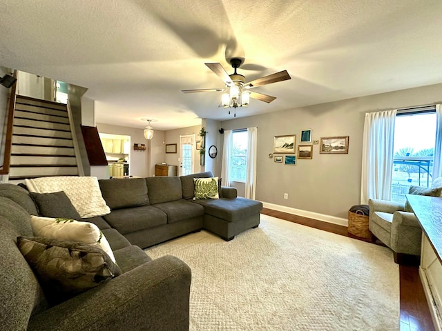 living room with hardwood / wood-style floors, a wealth of natural light, and a textured ceiling