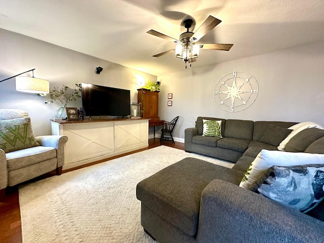 living room featuring ceiling fan and hardwood / wood-style floors