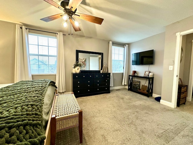 bedroom featuring ceiling fan and carpet