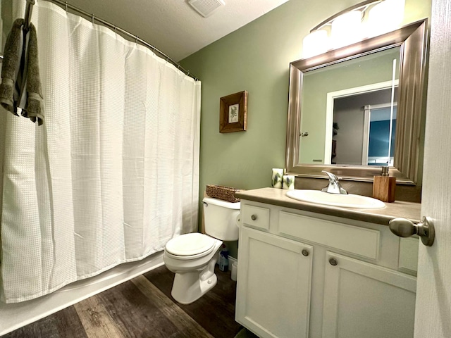 full bathroom featuring vanity, wood-type flooring, toilet, and shower / bathtub combination with curtain