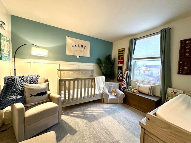 carpeted bedroom with a crib