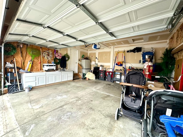 garage with a garage door opener and a workshop area