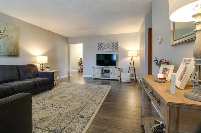 living room with a textured ceiling and dark hardwood / wood-style flooring