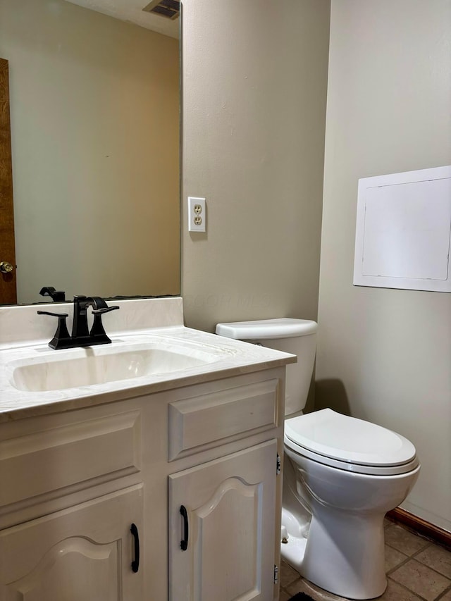 bathroom featuring tile patterned floors, vanity, and toilet