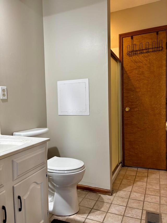 bathroom with vanity, an enclosed shower, and toilet