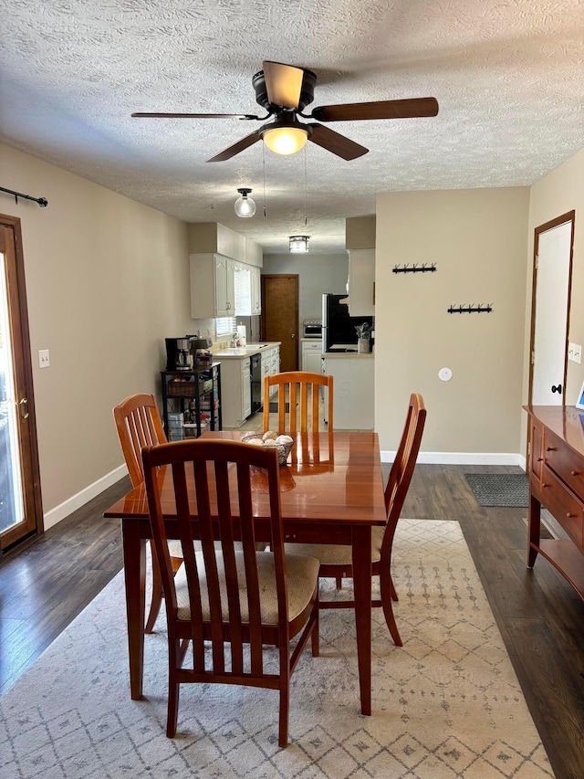 dining space featuring hardwood / wood-style flooring, ceiling fan, and a textured ceiling