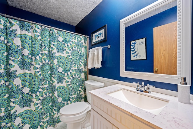 bathroom with curtained shower, toilet, wainscoting, a textured ceiling, and vanity