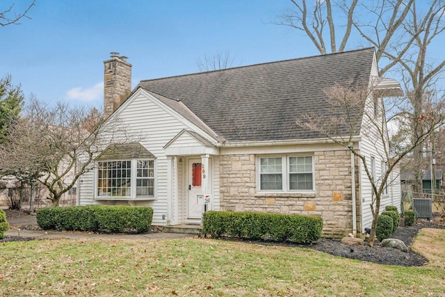 view of front of house featuring central AC and a front lawn