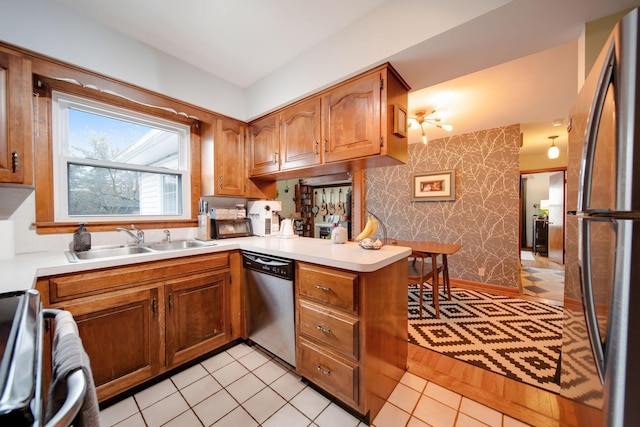 kitchen featuring appliances with stainless steel finishes, kitchen peninsula, and sink