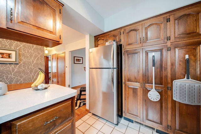 kitchen featuring stainless steel fridge and light tile patterned floors