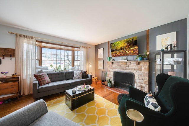 living room with hardwood / wood-style flooring and a fireplace