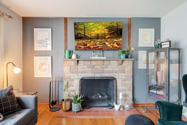 living room with a fireplace and light wood-type flooring