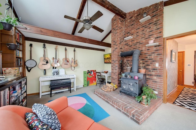 living room with beamed ceiling, ceiling fan, high vaulted ceiling, and a wood stove