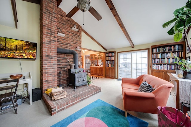 living room with high vaulted ceiling, a wood stove, ceiling fan, beamed ceiling, and light colored carpet