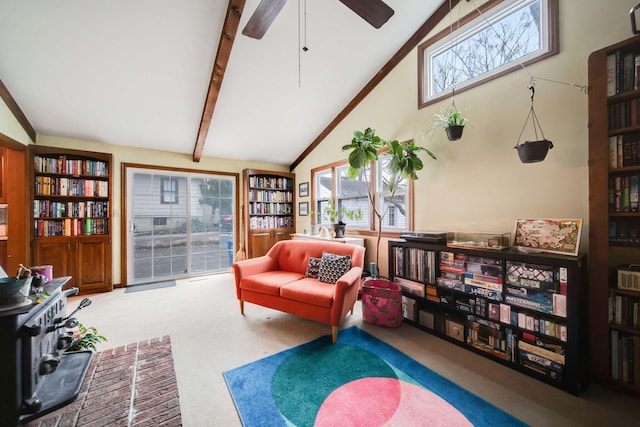 sitting room with beamed ceiling, high vaulted ceiling, a healthy amount of sunlight, and carpet