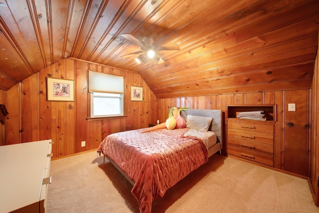 carpeted bedroom featuring lofted ceiling, wood ceiling, wooden walls, and ceiling fan