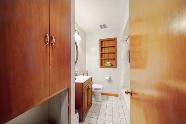 bathroom featuring built in features, tile patterned flooring, a shower with shower curtain, vanity, and toilet