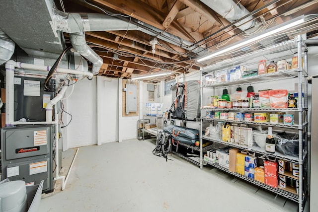 basement featuring heating unit and electric panel