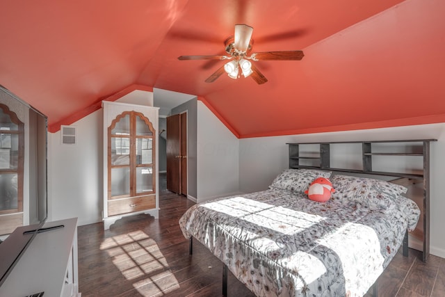 bedroom featuring dark wood-style floors, lofted ceiling, visible vents, and baseboards