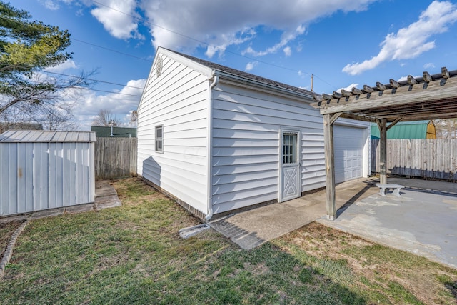 view of shed featuring fence