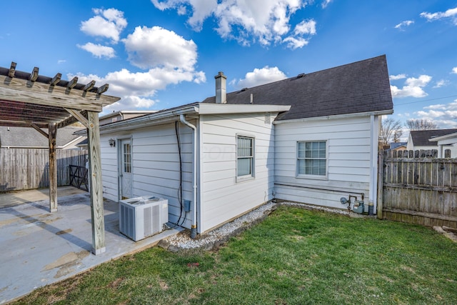 rear view of house with a patio, central air condition unit, a lawn, a pergola, and fence private yard