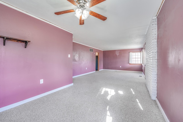 empty room featuring a ceiling fan, crown molding, and baseboards