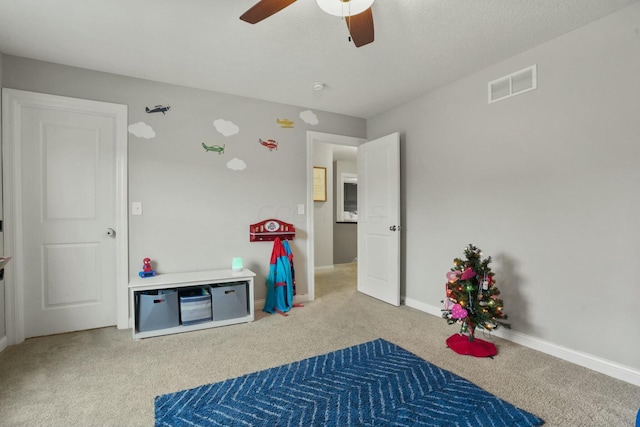 recreation room with ceiling fan and carpet floors