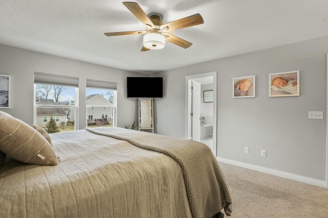 carpeted bedroom featuring ceiling fan, connected bathroom, and a textured ceiling