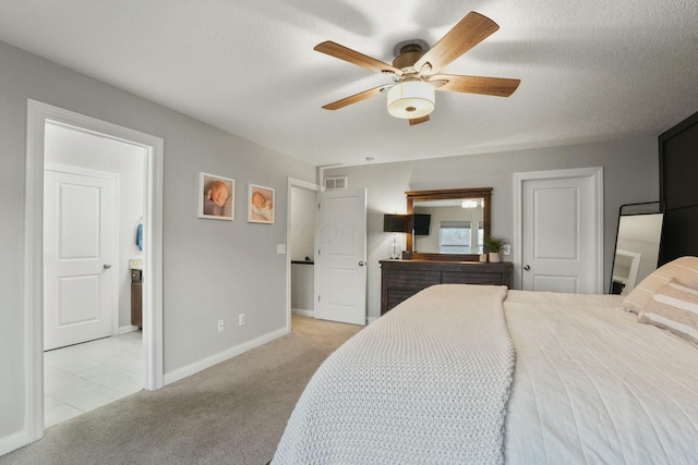 carpeted bedroom featuring ceiling fan and a textured ceiling